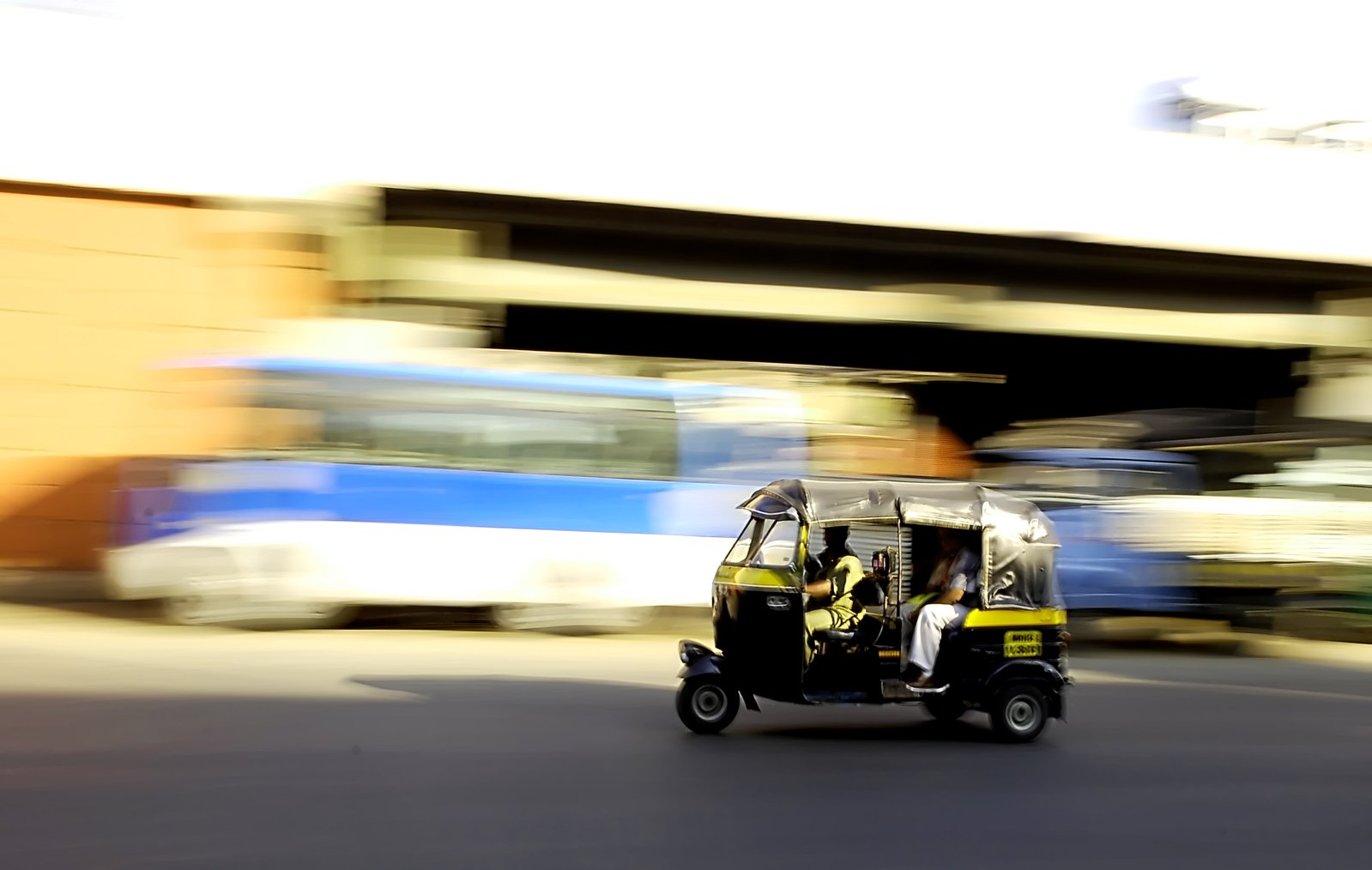 a man driving a three passenger buggy down a street