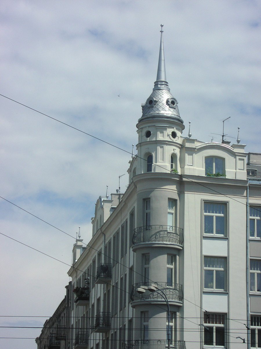 an ornate white building with steeple and power lines
