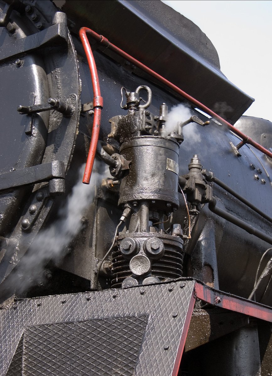 a closeup s of the smoke coming out of an old fashioned steam engine