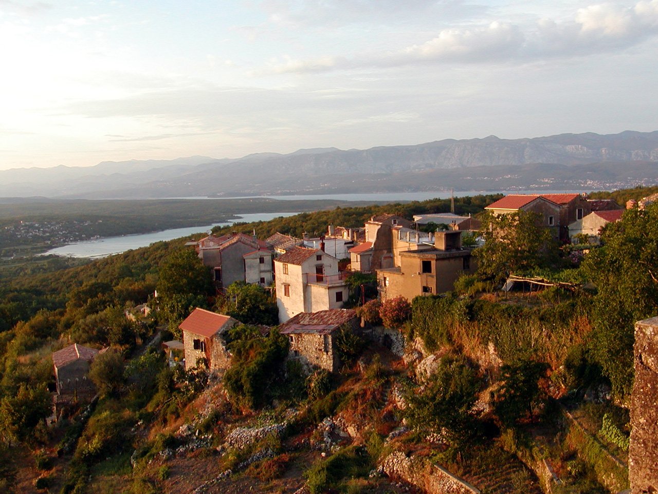 a view from a high above of several buildings on top of a hill