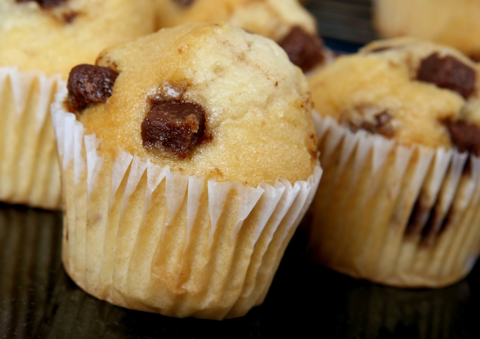 several muffins on a table with chocolate chips in them