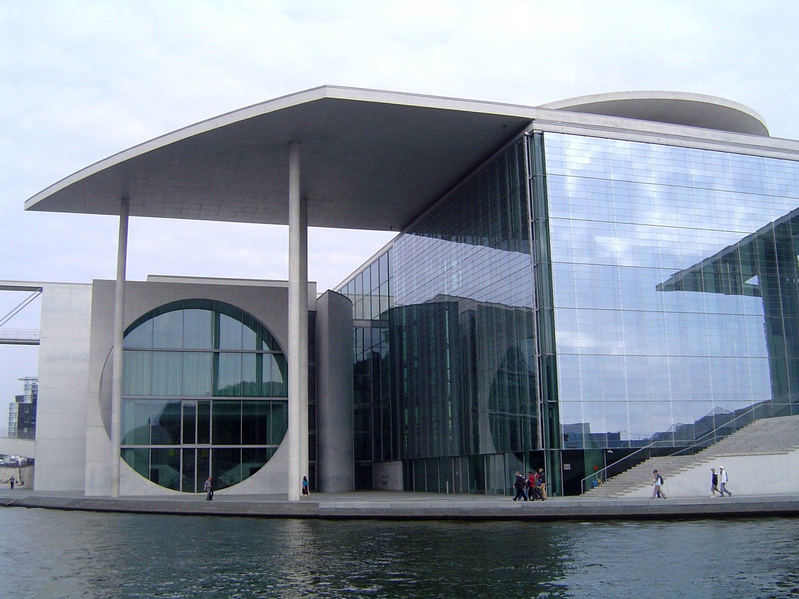 a building with several circular windows is situated over the water