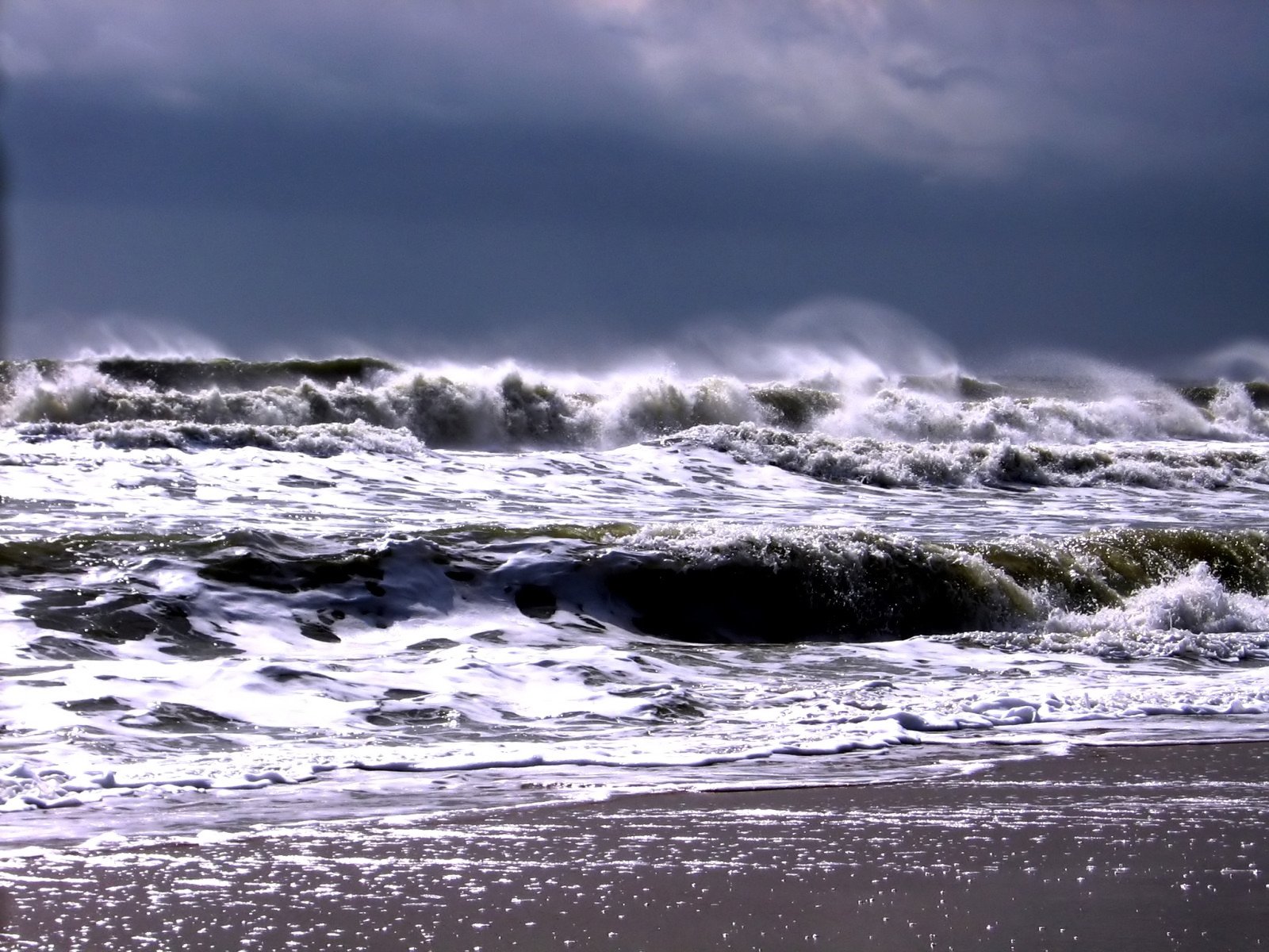 a large body of water surrounded by waves