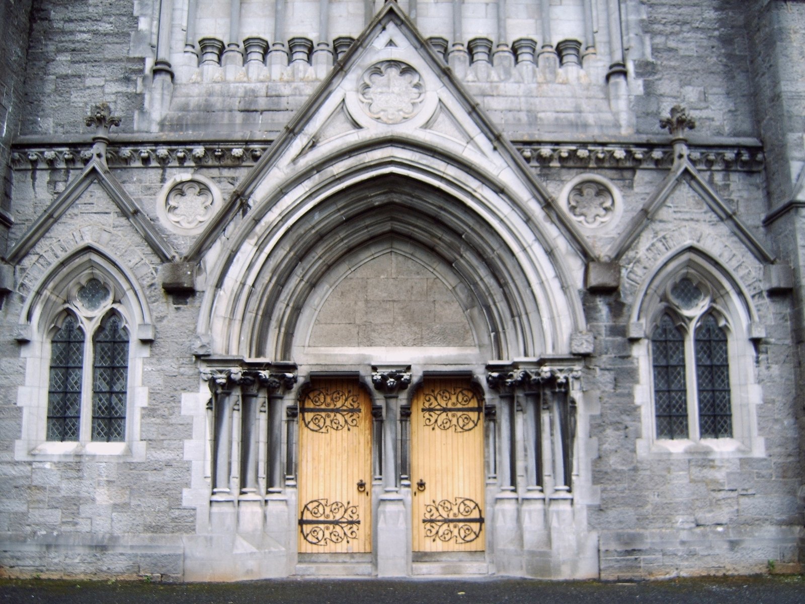 two massive wooden doors in front of an old church