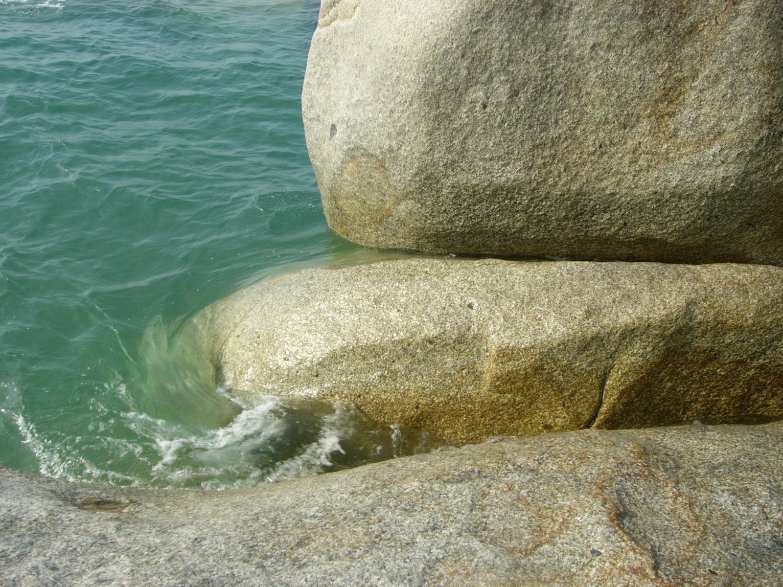 large, large and small rocks in front of the ocean