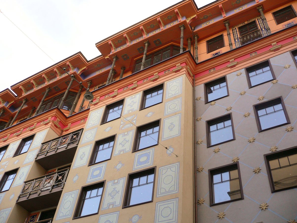 a multicolored building has many windows and ornate design