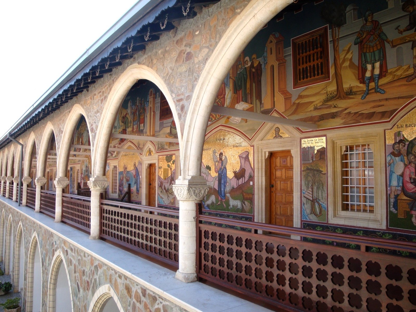 a balcony in a building with murals painted on it