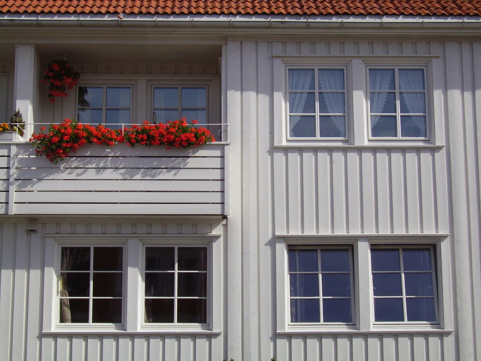 an apartment building with windows that have planters above it