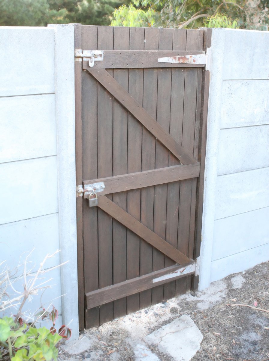 an opened barn door with steel latchs is shown