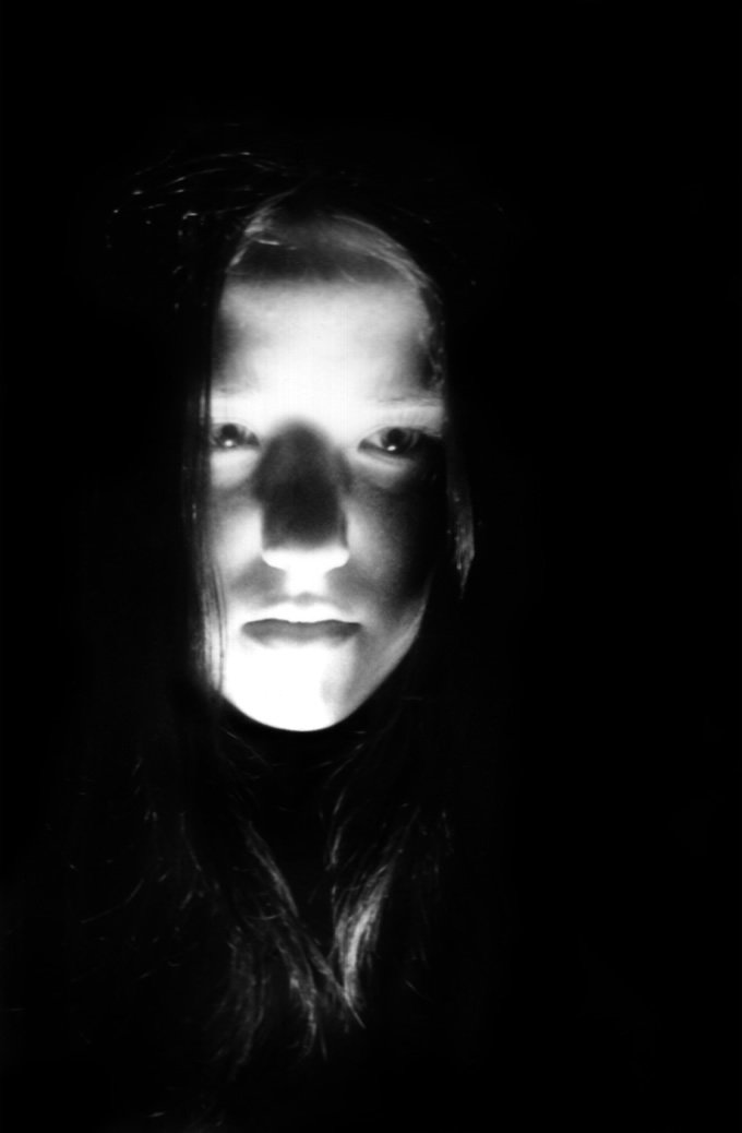 the silhouette of a woman in black with long hair