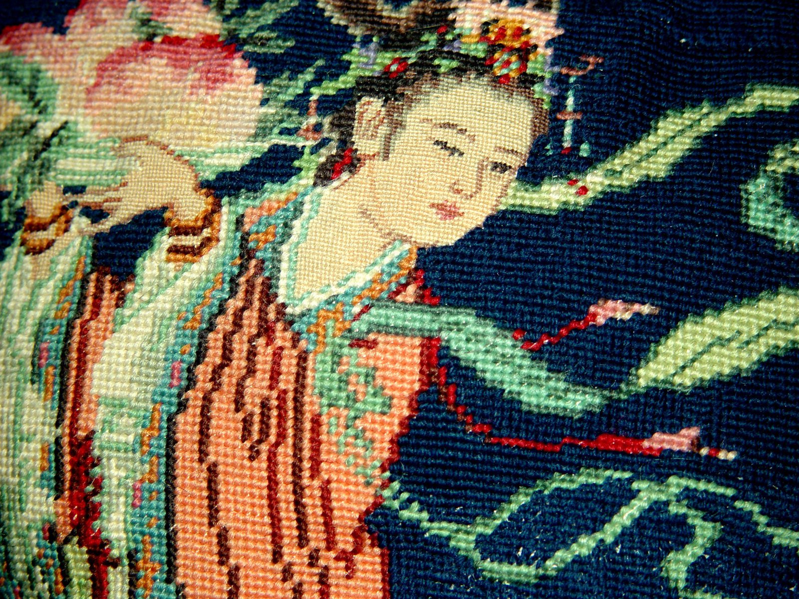 a needle - embroidery work on a blue background showing a beautiful woman