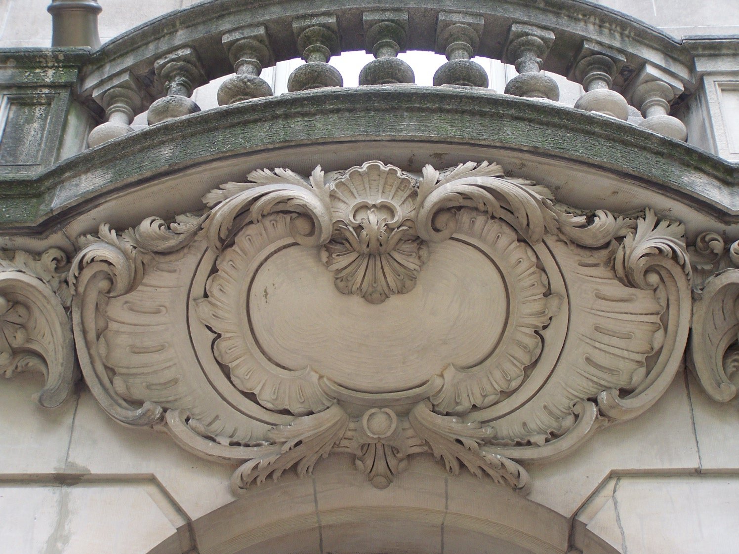 an ornamental, stucco building decorated with carvings and birds