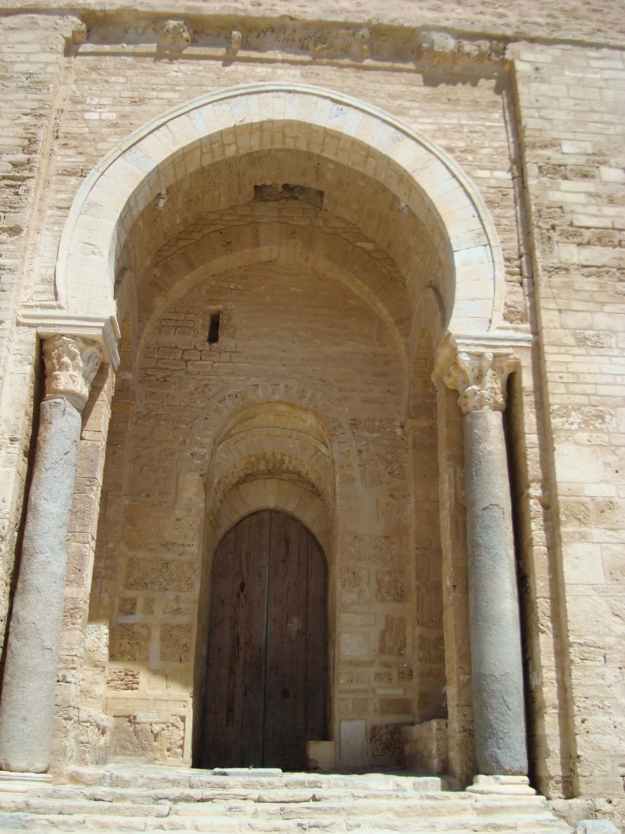 an old door with pillars and doors in stone building