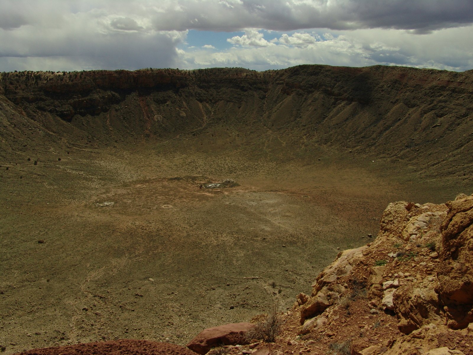 a barren landscape with sp rocks on the edge