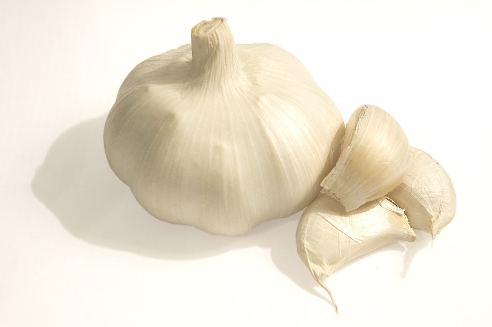 two pieces of garlic on top of a white table