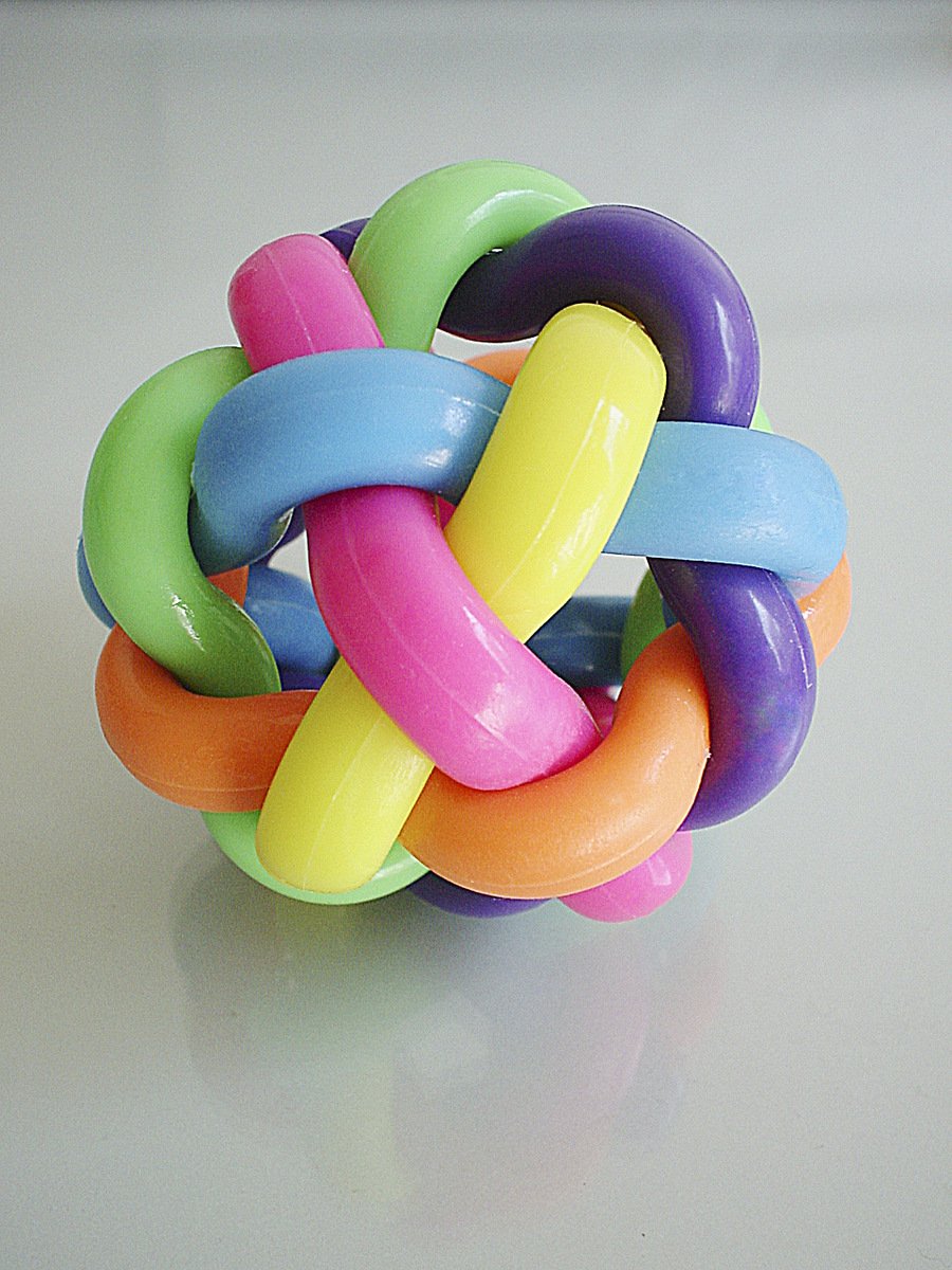 a colorful toy is on a table with a silver surface