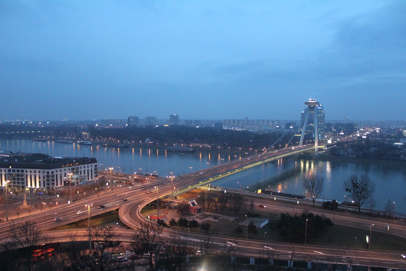 an aerial view of a city with river and bridges