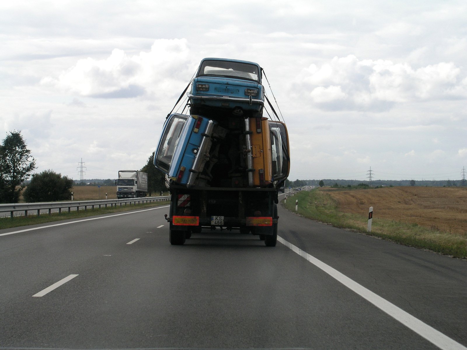 a blue truck is parked in a semi - truck lane