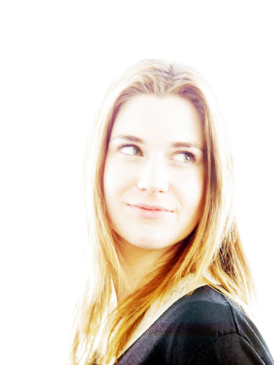 a woman's face and shoulder portrait in black shirt