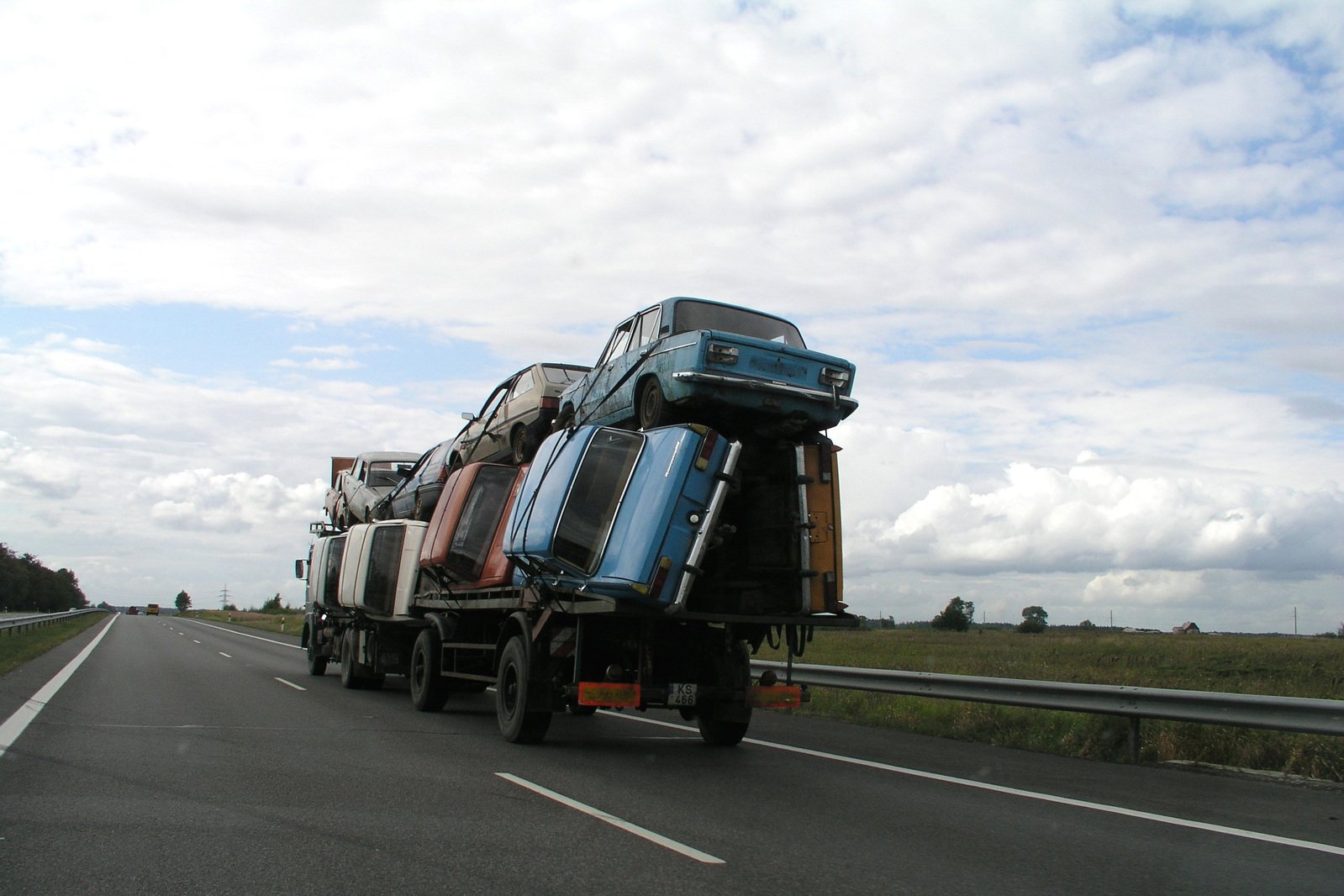 a group of large trucks driving down a road
