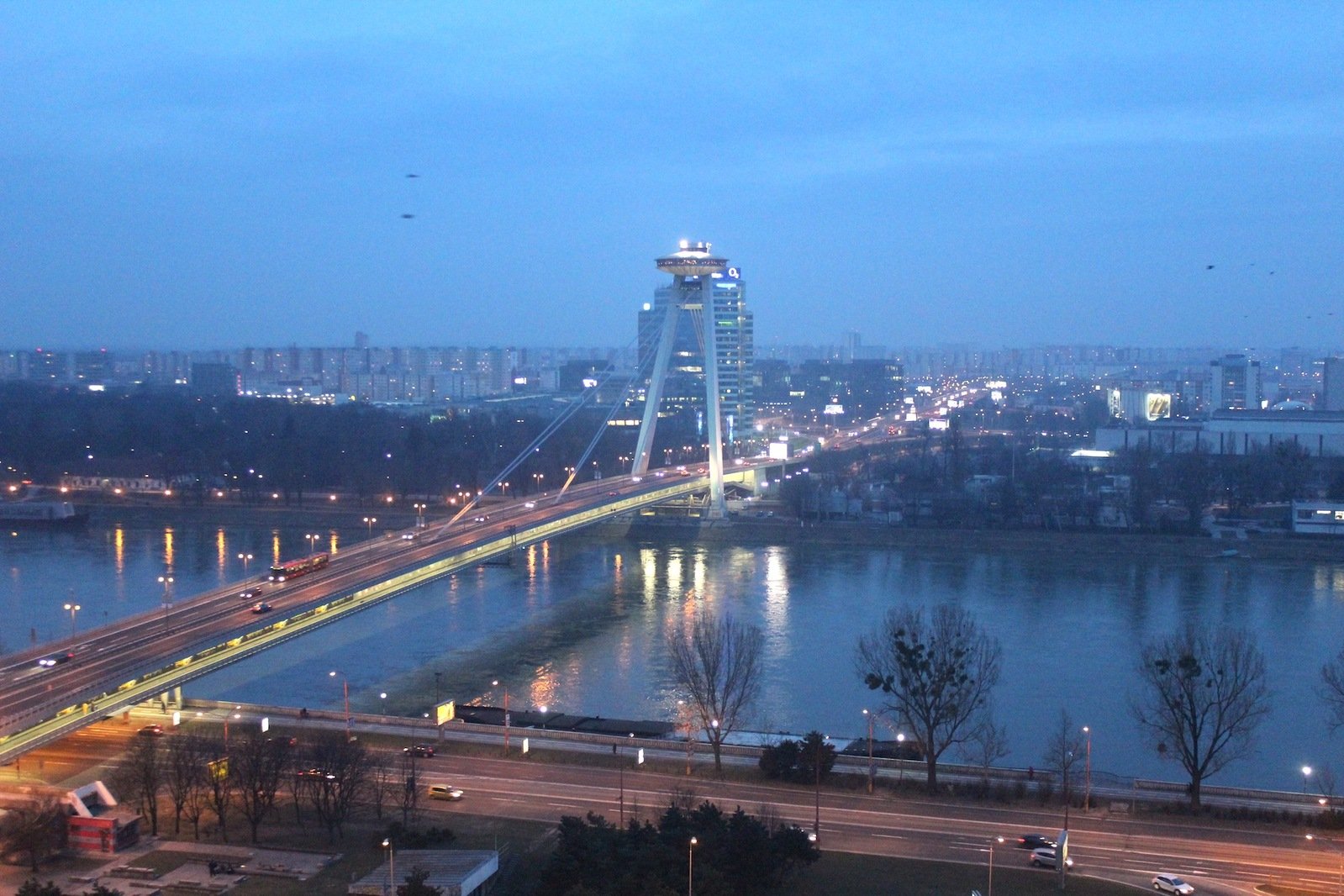 the lights are on on a bridge over the water