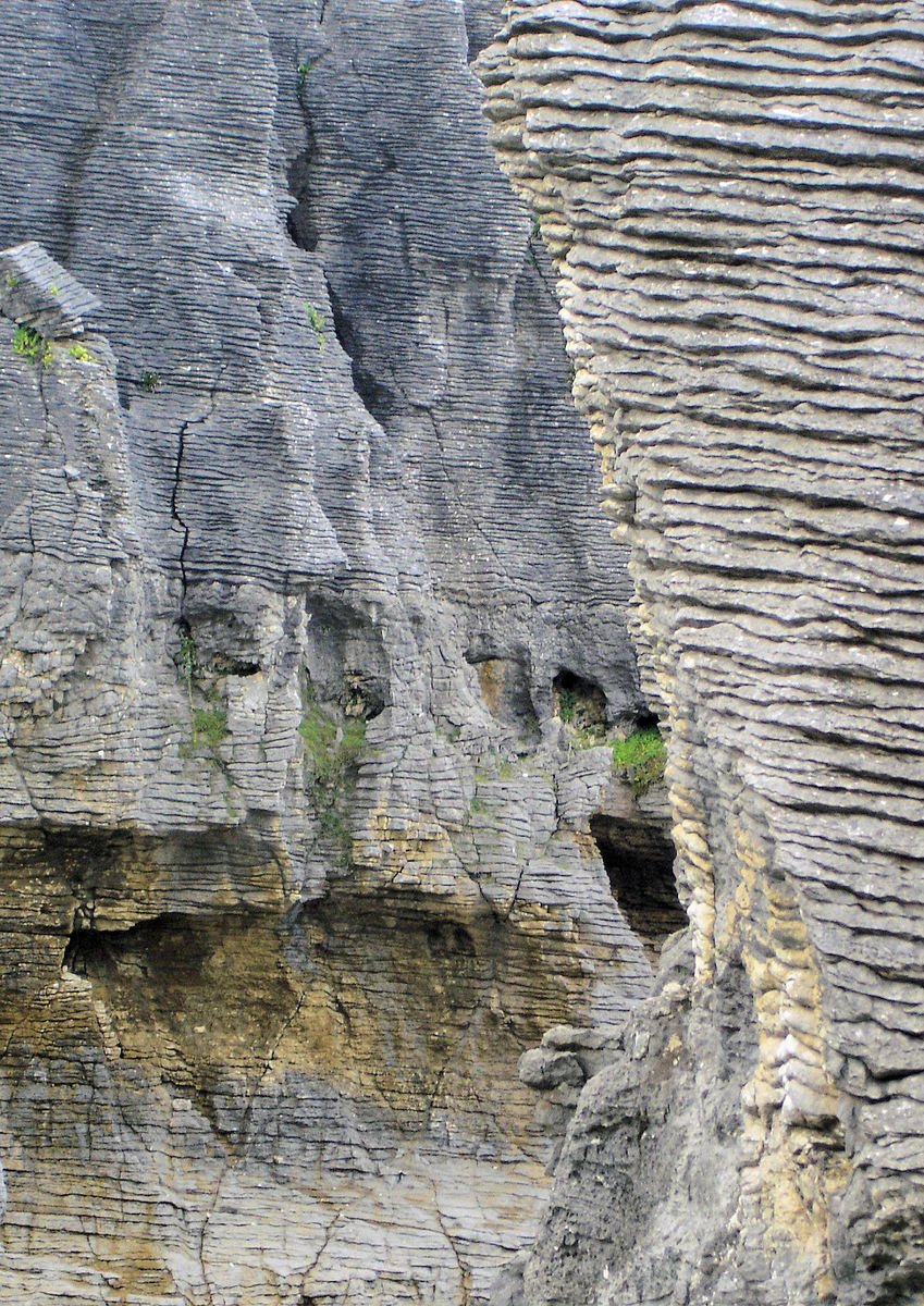 close up view of a cliff with some very large rocks