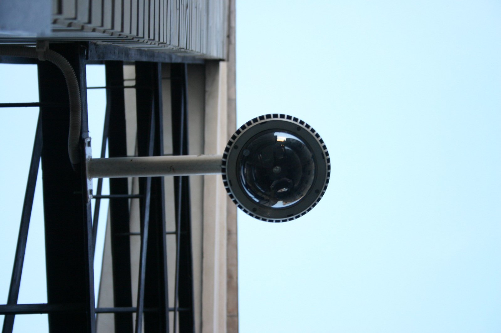 a small cci camera hangs outside the window