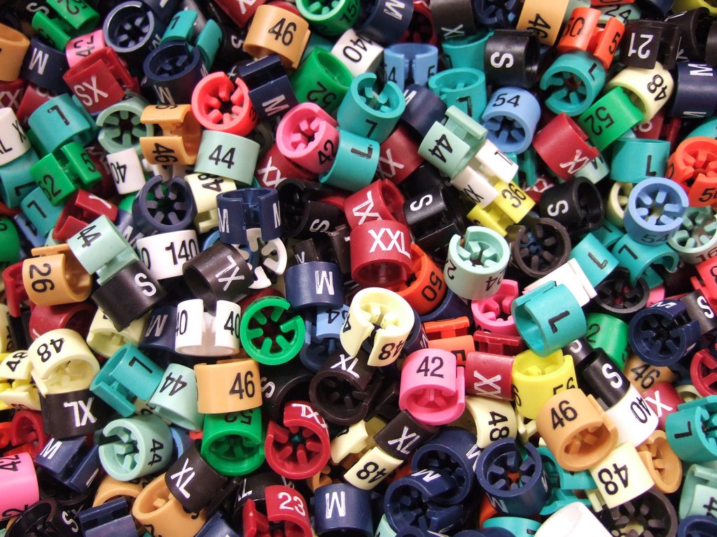 a pile of colorful dice with numbers and numbers written on them