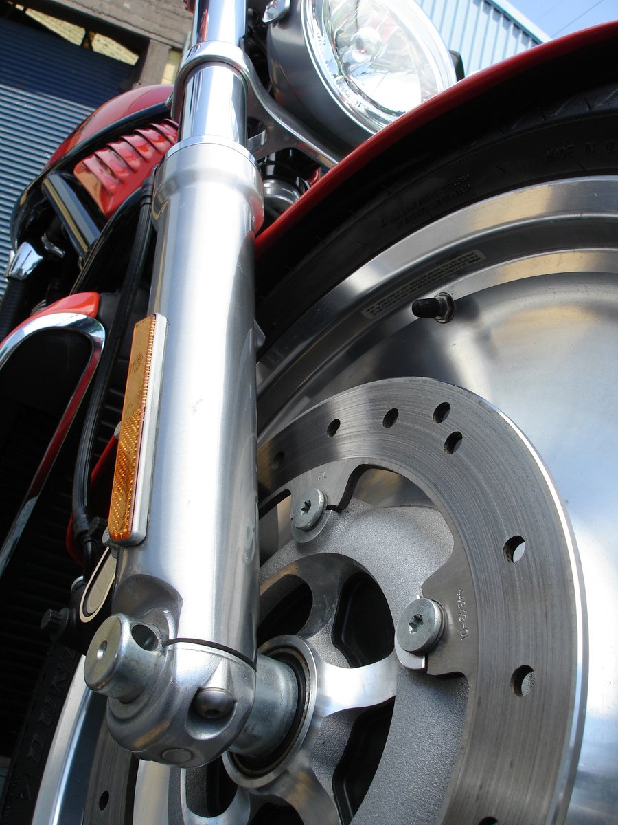 front wheel of a motorcycle parked next to a building