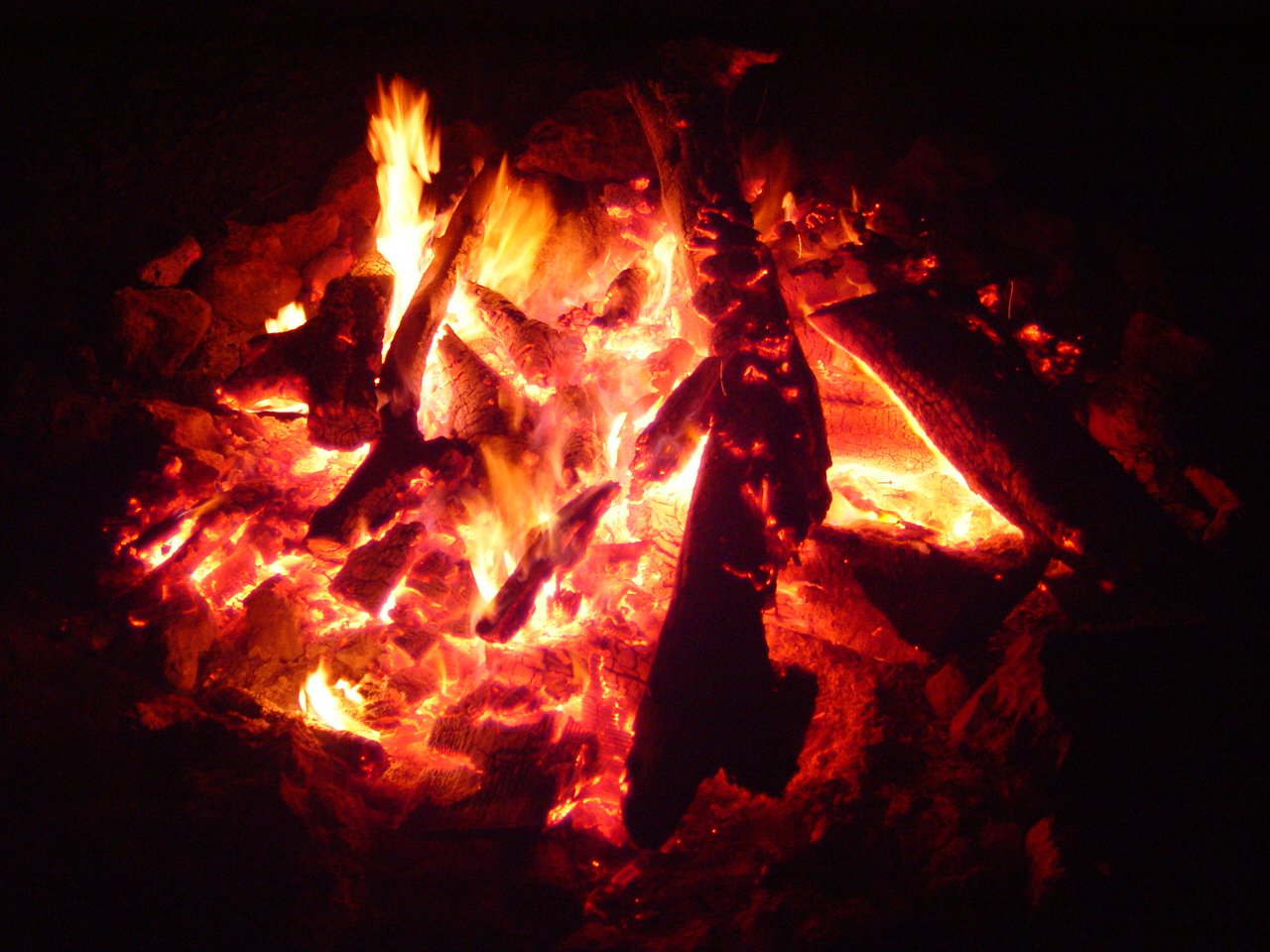 a campfire with several fires and bright flames