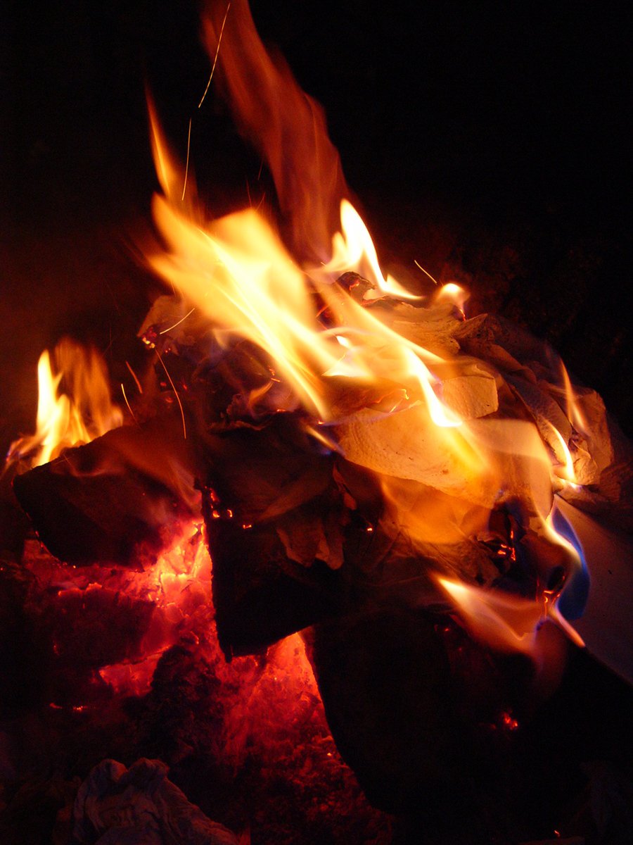 a close up of flames and rocks in the dark