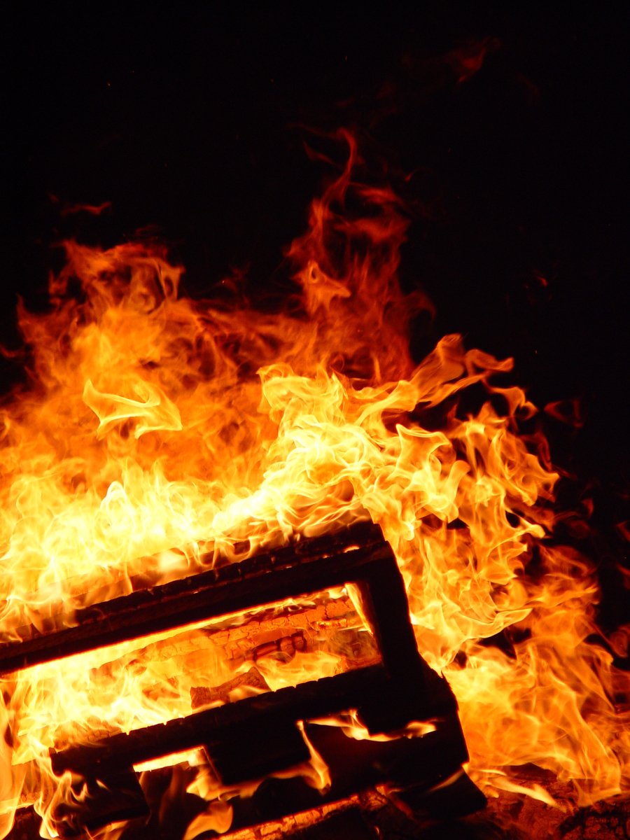 a wooden bench sitting on top of a fire pit