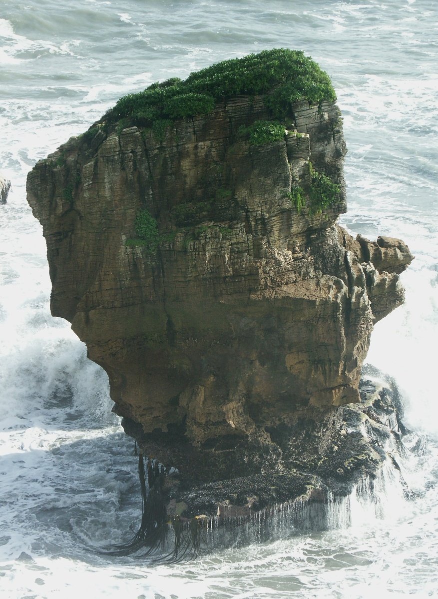 this large rock is sticking out of the water