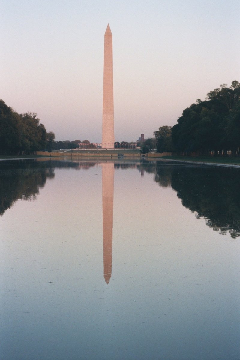 the washington monument is reflected in the water