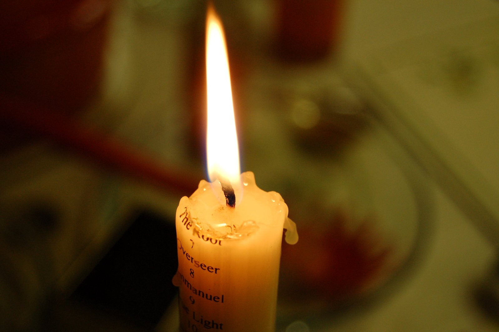 an orange candle has a poem written on it