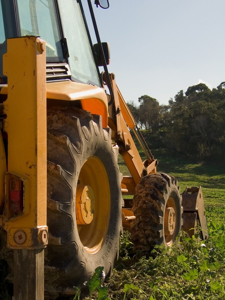 the tractor is driving through the lush green field