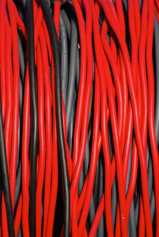 a pile of red, black, and gray electrical wires