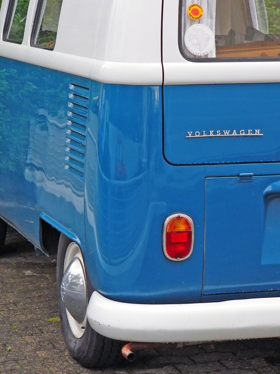 a blue and white van is parked in a lot