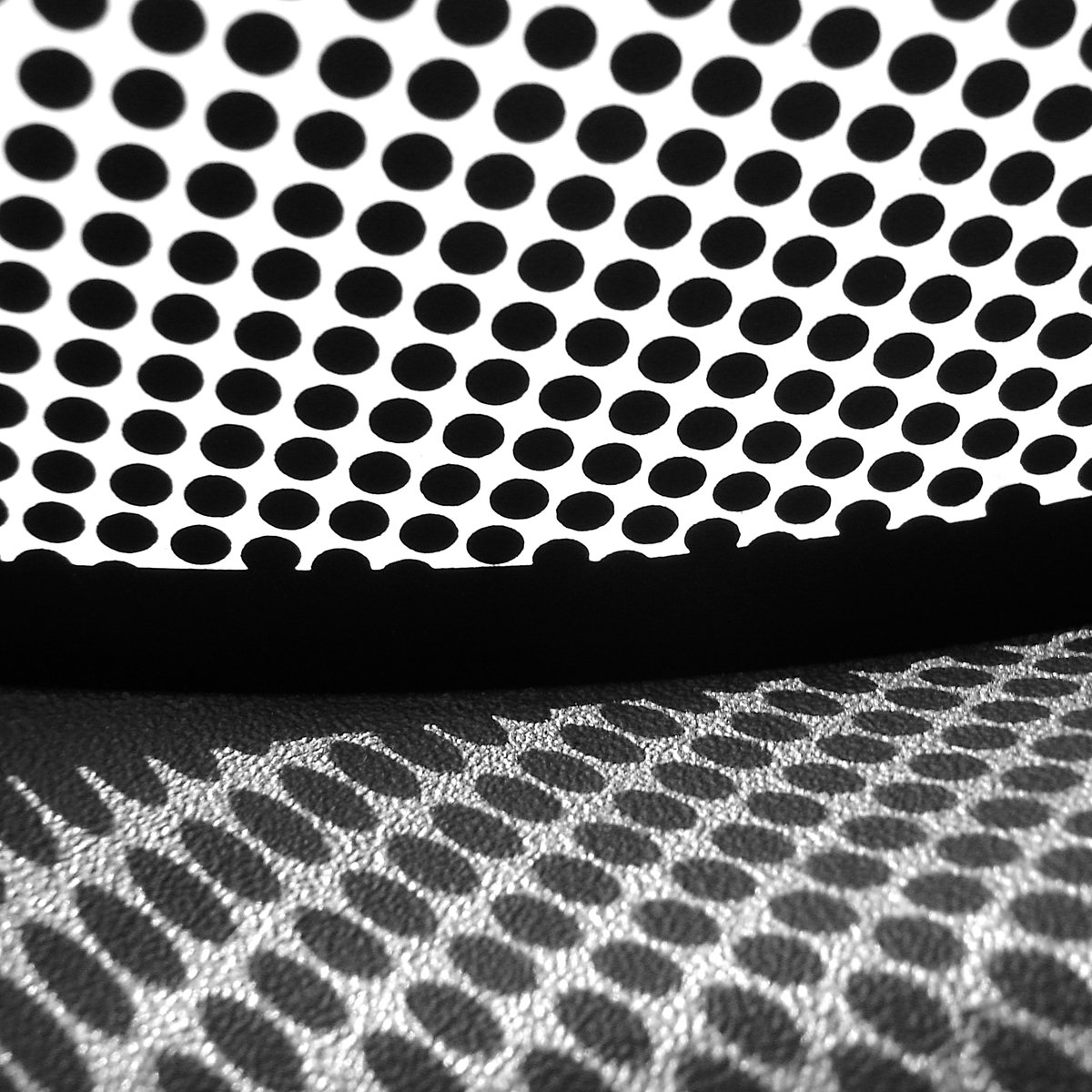 a black and white picture of a pillow with black circles