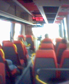 a view from inside a bus showing rows of seats