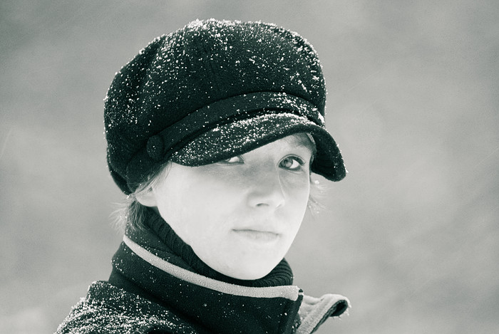 a girl with a cap and scarf on