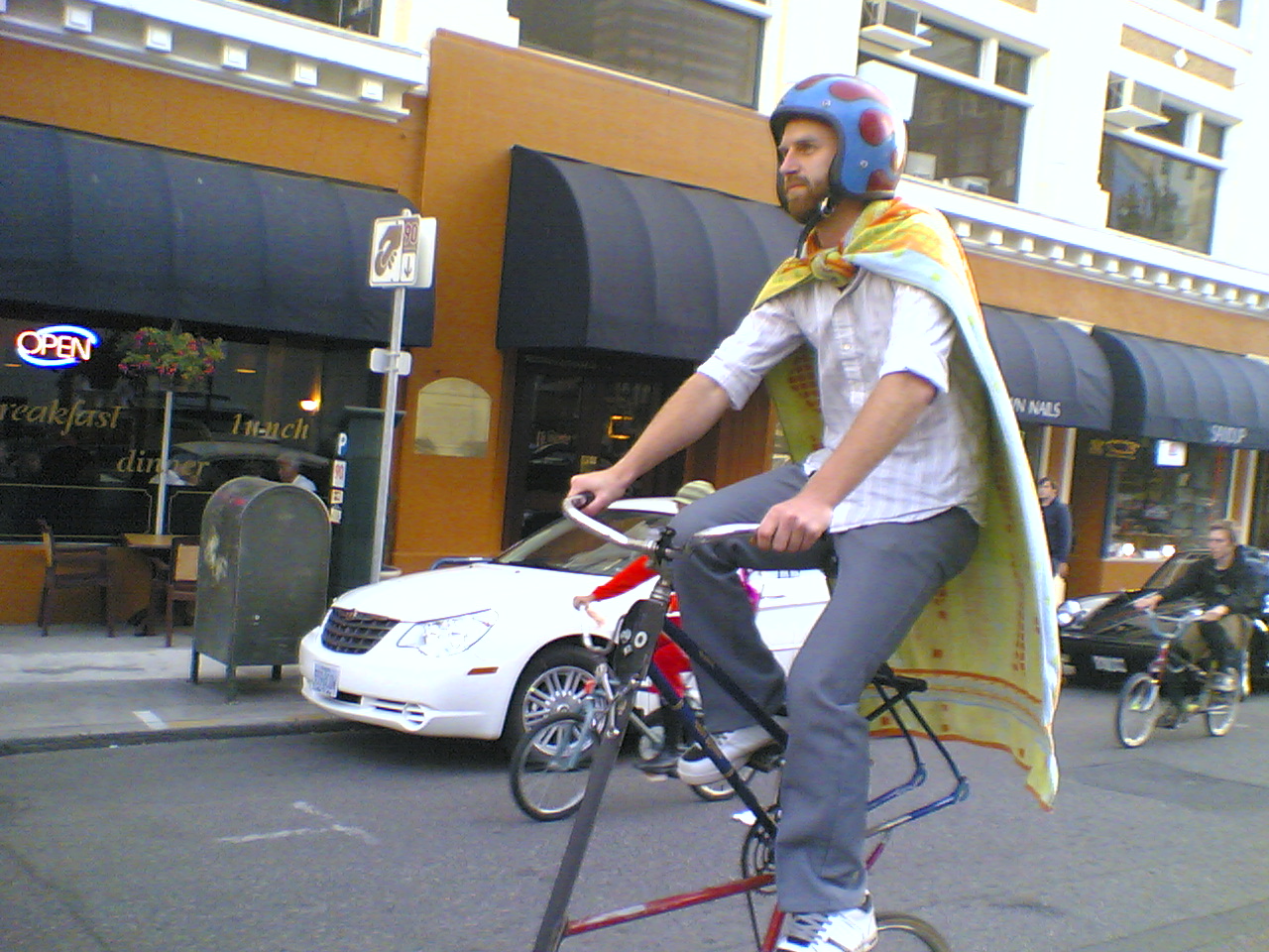 a man on a bicycle with the seat folded up
