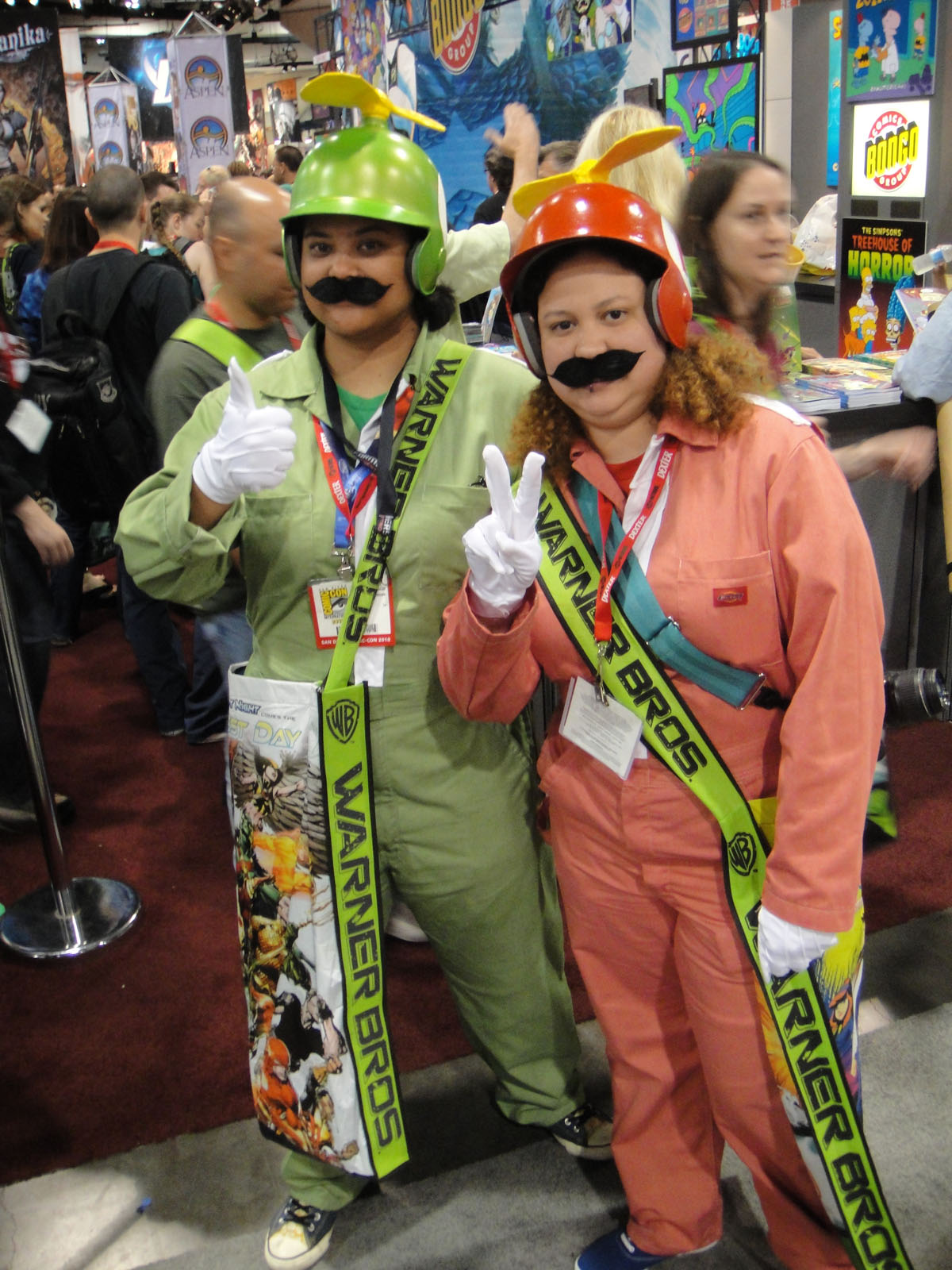 two people dressed as characters in costumes for a convention