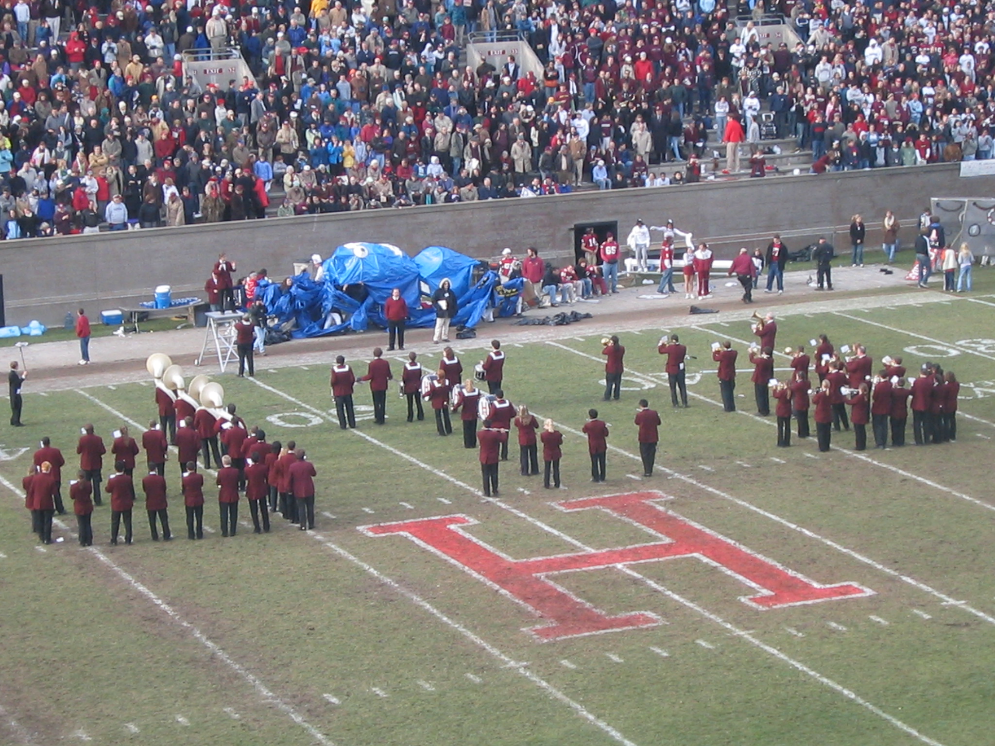 a band on a football field with other people watching