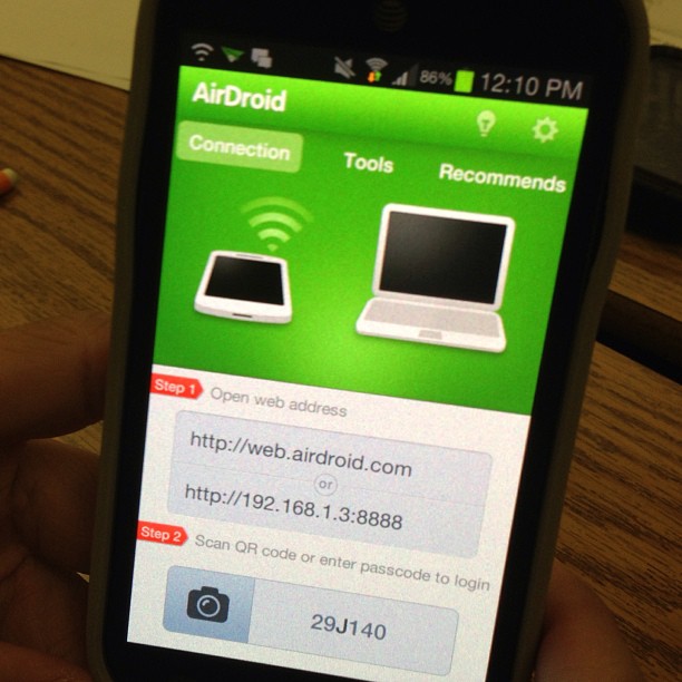 an iphone in someone's hand displaying different web application