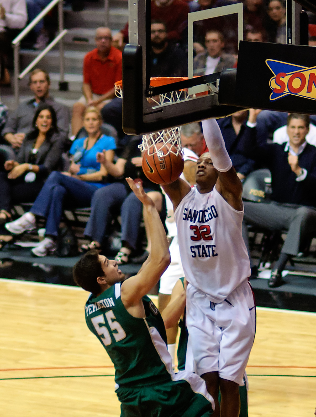 a man getting ready to dunk a basketball