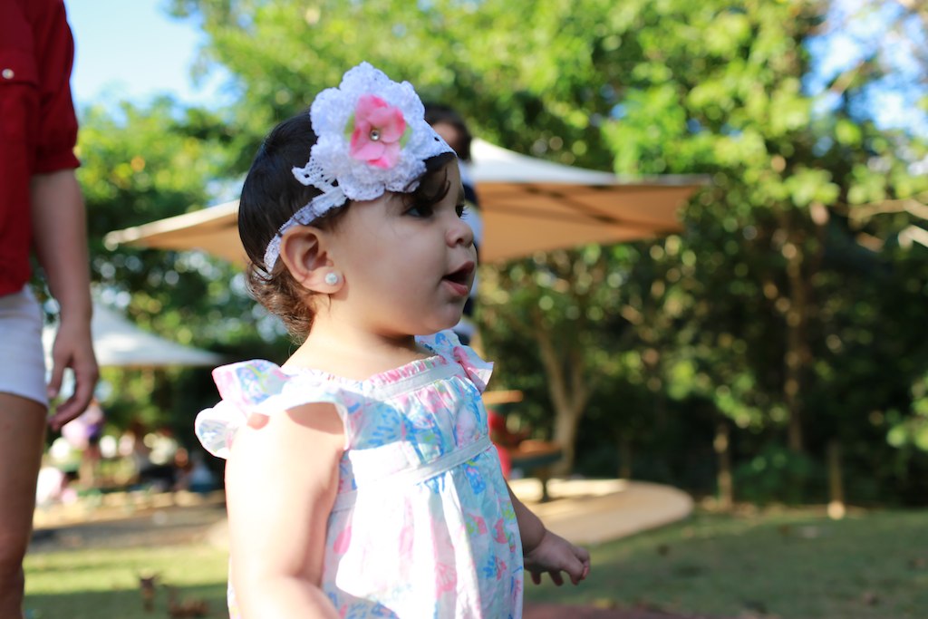 a little girl wearing flowers and a headband