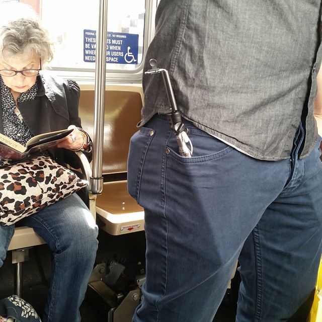 an old woman sitting in a seat on a subway reading a book
