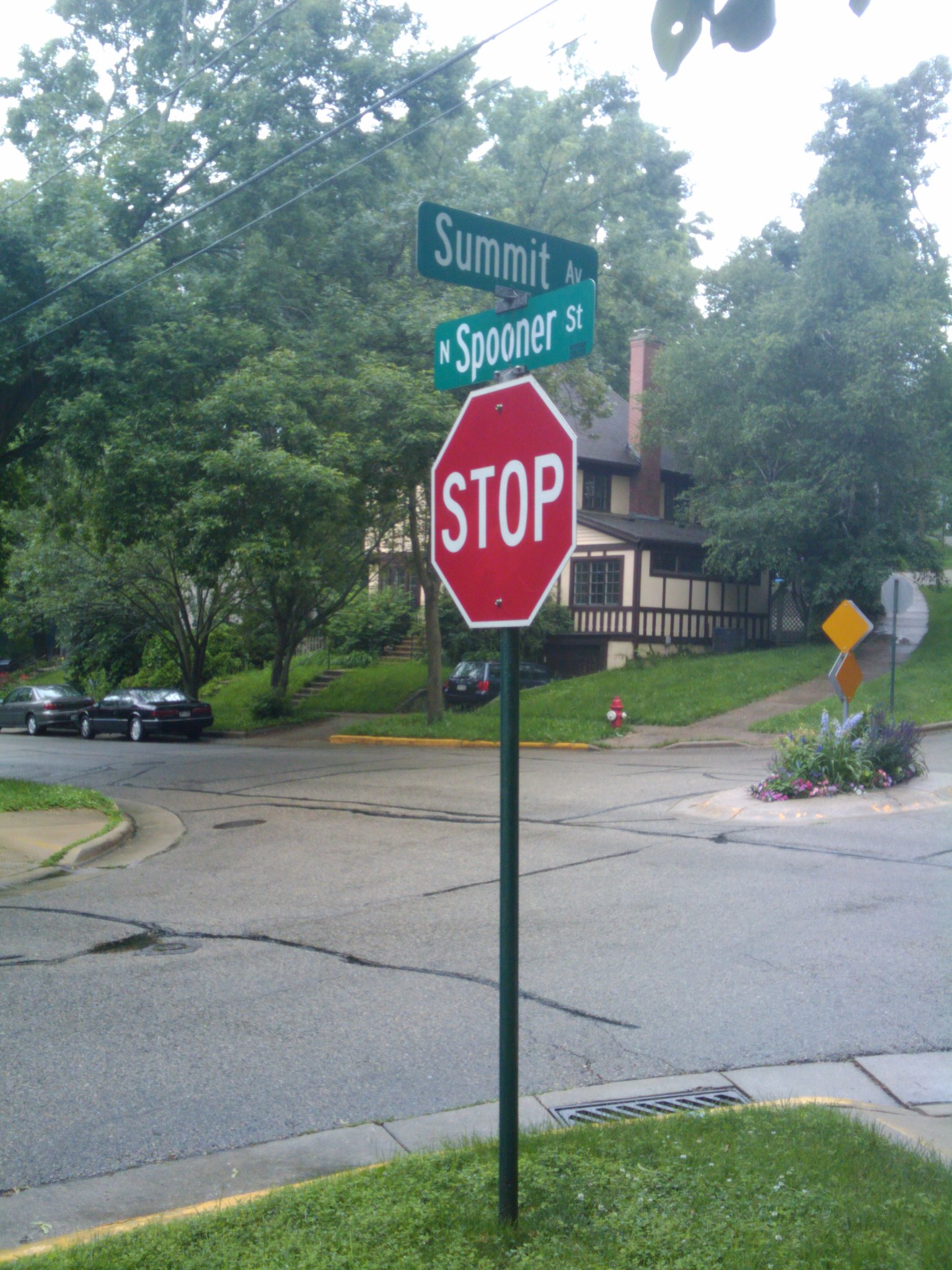a stop sign is near an intersection in a suburban setting
