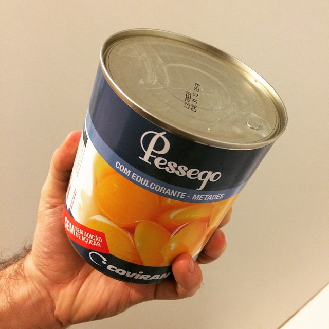 a person holds up a can of canned food